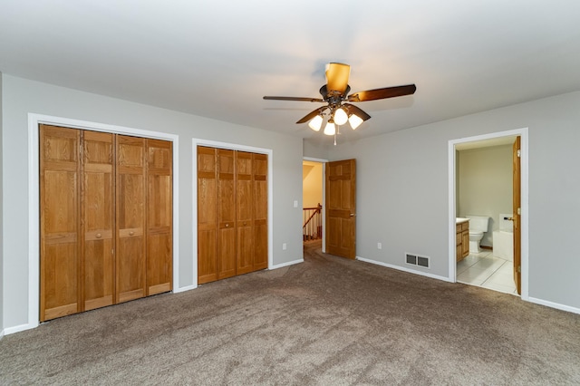 2319 Viola View Ln NE, Rochester, MN 55906 - unfurnished bedroom with multiple closets, carpet flooring, ensuite bathroom, and ceiling fan