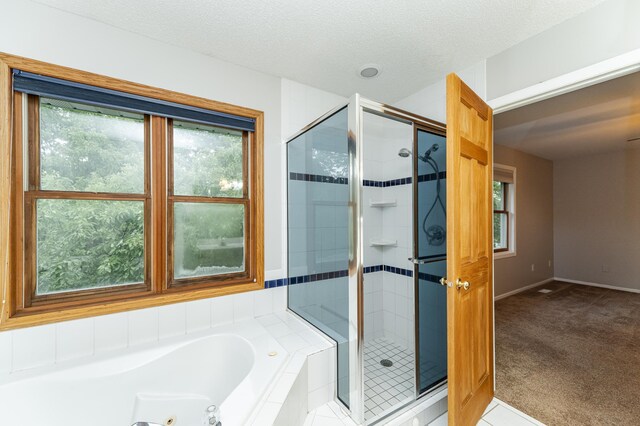 2319 Viola View Ln NE, Rochester, MN 55906 - bathroom featuring a stall shower, a jetted tub, and a textured ceiling