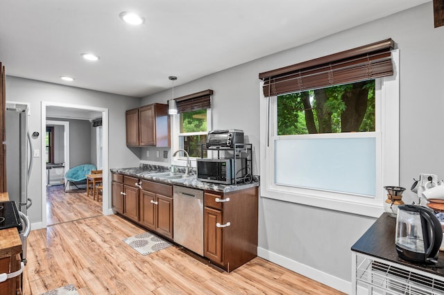 3256 Sheridan Ave N, Minneapolis, MN 55412 - kitchen with stainless steel appliances, light wood-style floors, recessed lighting, pendant lighting, and stone countertops
