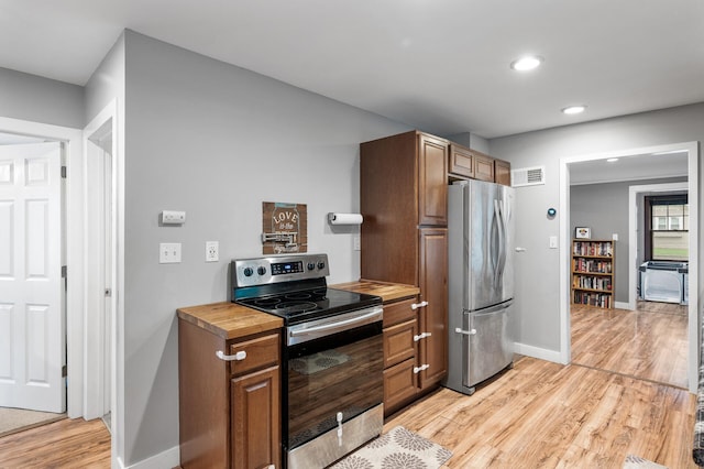 3256 Sheridan Ave N, Minneapolis, MN 55412 - kitchen with appliances with stainless steel finishes, light wood-type flooring, recessed lighting, and butcher block countertops