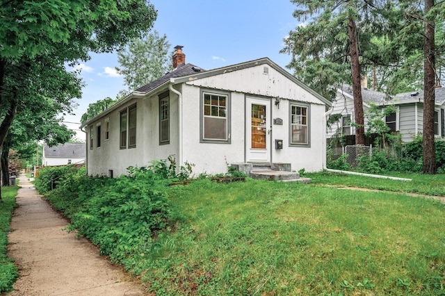 3256 Sheridan Ave N, Minneapolis, MN 55412 - view of front of home with a chimney and stucco siding