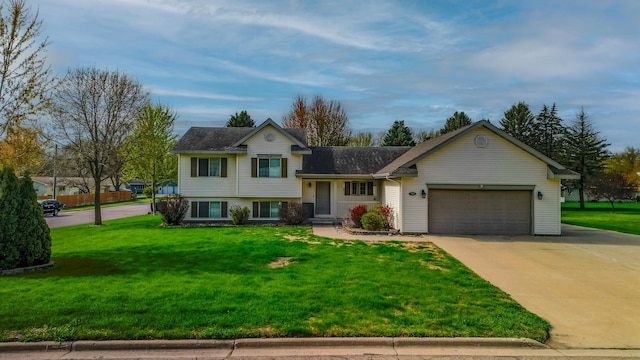 704 Main St, Madelia, MN 56062 - tri-level home with an attached garage, driveway, and a front yard