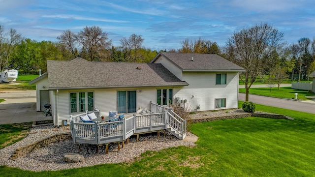 704 Main St, Madelia, MN 56062 - rear view of property featuring a yard, a wooden deck, and a shingled roof