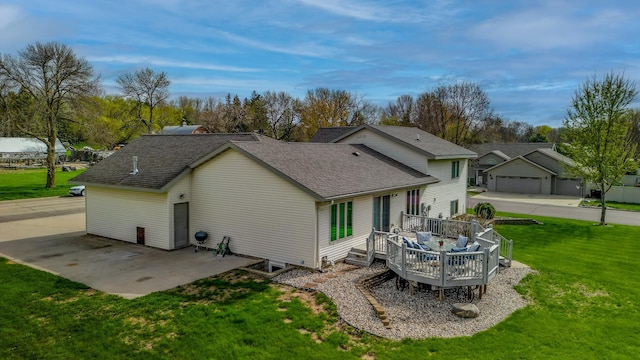 704 Main St, Madelia, MN 56062 - rear view of house with a deck, a yard, and roof with shingles