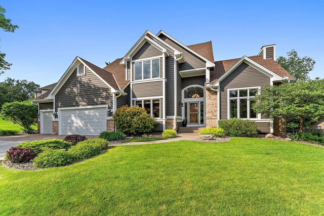 11582 Raspberry Hill Rd, Eden Prairie, MN 55344 - view of front of home featuring an attached garage, a front yard, driveway, and a shingled roof