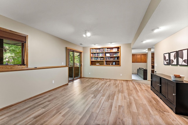 11582 Raspberry Hill Rd, Eden Prairie, MN 55344 - unfurnished living room featuring light wood finished floors, built in shelves, and decorative columns