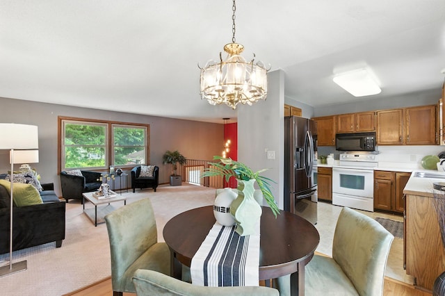 507 17 1/2 St SE, Rochester, MN 55904 - dining area with a chandelier and light colored carpet