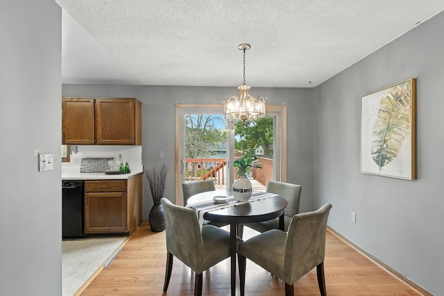 507 17 1/2 St SE, Rochester, MN 55904 - dining room featuring a chandelier, light wood-style flooring, and a textured ceiling