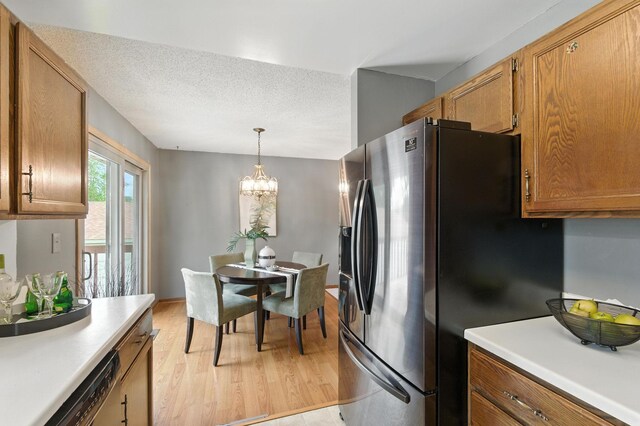 507 17 1/2 St SE, Rochester, MN 55904 - kitchen with appliances with stainless steel finishes, light wood-style floors, brown cabinets, light countertops, and hanging light fixtures