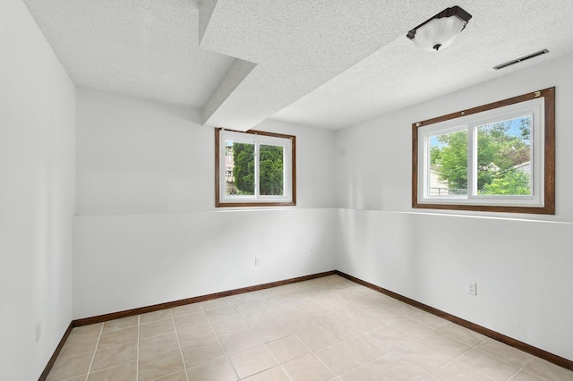 507 17 1/2 St SE, Rochester, MN 55904 - spare room with plenty of natural light and a textured ceiling