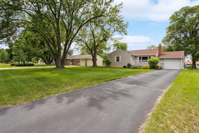 6342 Baker Ave NE, Fridley, MN 55432 - ranch-style house with driveway, a chimney, a front yard, and a garage