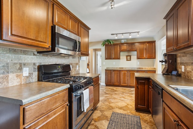6342 Baker Ave NE, Fridley, MN 55432 - kitchen with appliances with stainless steel finishes, tasteful backsplash, brown cabinets, and track lighting