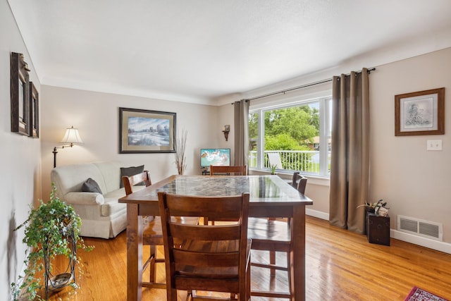 6342 Baker Ave NE, Fridley, MN 55432 - dining space featuring light wood-type flooring and baseboards
