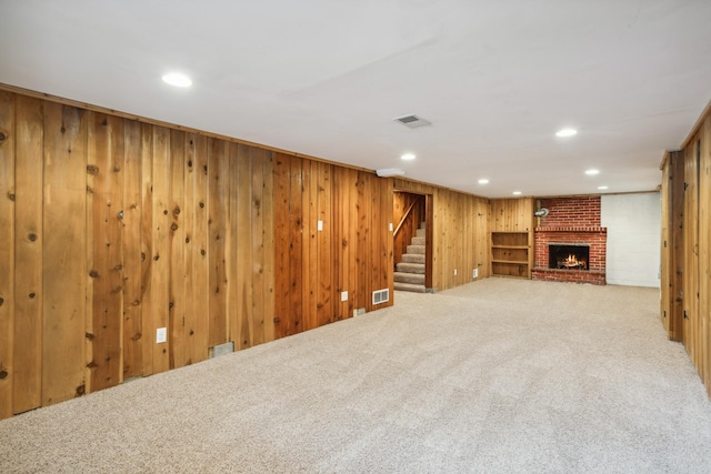 6342 Baker Ave NE, Fridley, MN 55432 - finished basement with carpet flooring, stairs, wood walls, a brick fireplace, and recessed lighting