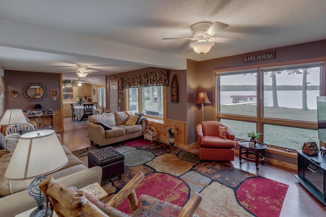 35139 County 39, Laporte, MN 56461 - living area with a ceiling fan, wood finished floors, wainscoting, and a textured ceiling