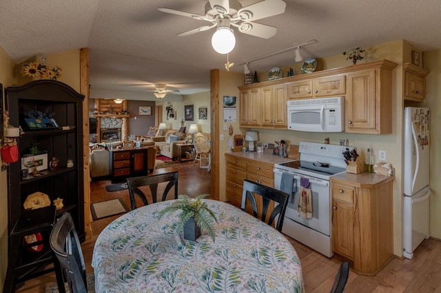 35139 County 39, Laporte, MN 56461 - kitchen featuring white appliances, a ceiling fan, light countertops, light brown cabinetry, and light wood-type flooring