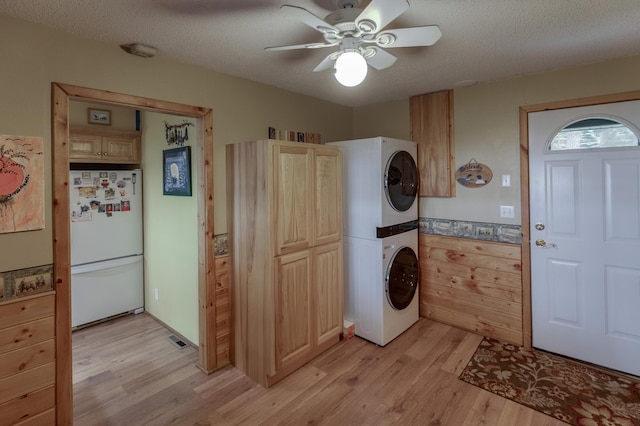 35139 County 39, Laporte, MN 56461 - washroom featuring stacked washer / drying machine, light wood finished floors, ceiling fan, and a textured ceiling