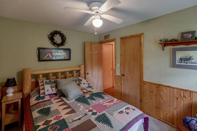 35139 County 39, Laporte, MN 56461 - carpeted bedroom with wainscoting, wooden walls, and ceiling fan