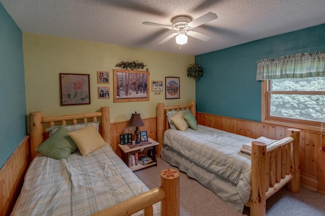 35139 County 39, Laporte, MN 56461 - carpeted bedroom with wainscoting, a textured ceiling, ceiling fan, and wooden walls