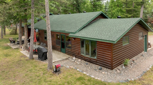 35139 County 39, Laporte, MN 56461 - rear view of property featuring roof with shingles, faux log siding, a lawn, a patio area, and a deck