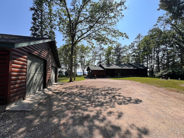 35139 County 39, Laporte, MN 56461 - view of property exterior with log veneer siding, an outbuilding, and a shingled roof