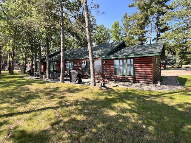 35139 County 39, Laporte, MN 56461 - back of house with log veneer siding, a lawn, and roof with shingles