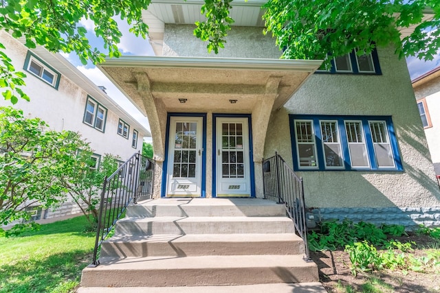 1787 Randolph Ave, Saint Paul, MN 55105 - view of exterior entry with stucco siding and covered porch