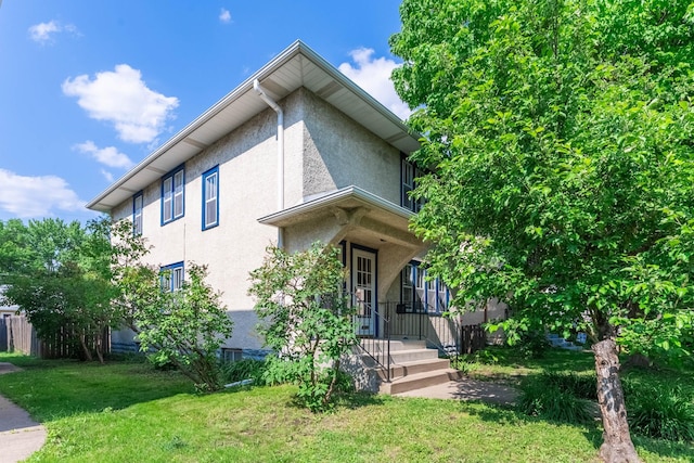 1787 Randolph Ave, Saint Paul, MN 55105 - view of front of house with stucco siding and a front lawn