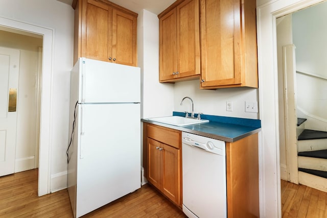 1787 Randolph Ave, Saint Paul, MN 55105 - kitchen with white appliances, light wood-style floors, brown cabinets, and dark countertops