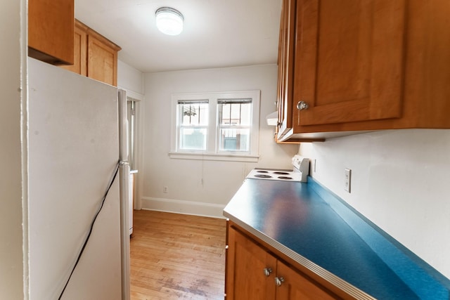 1787 Randolph Ave, Saint Paul, MN 55105 - kitchen with white appliances, brown cabinets, and light wood-type flooring