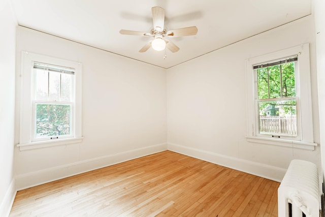 1787 Randolph Ave, Saint Paul, MN 55105 - empty room with radiator heating unit, light wood-type flooring, and a ceiling fan