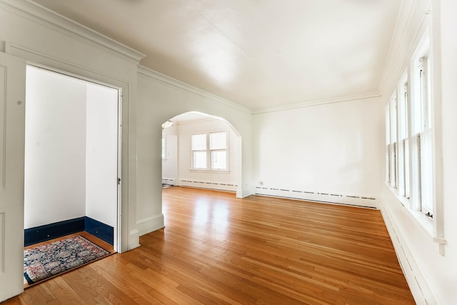 1787 Randolph Ave, Saint Paul, MN 55105 - spare room featuring arched walkways, a baseboard radiator, wood finished floors, and crown molding