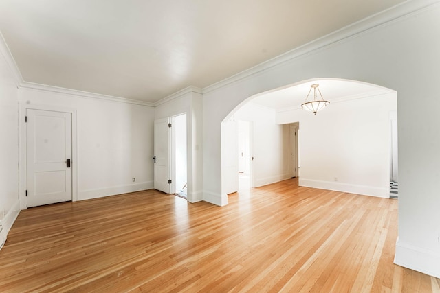 1787 Randolph Ave, Saint Paul, MN 55105 - empty room with arched walkways, light wood-style floors, ornamental molding, and a chandelier
