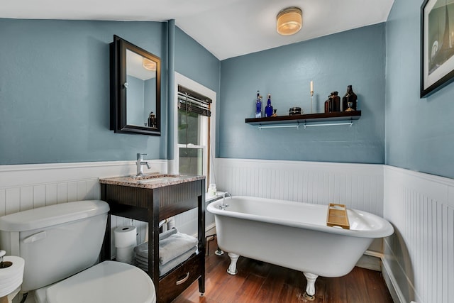 212 30th Ave N, Saint Cloud, MN 56303 - bathroom featuring wood finished floors, wainscoting, a freestanding tub, and vanity