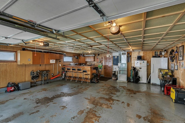 212 30th Ave N, Saint Cloud, MN 56303 - garage with freestanding refrigerator and wooden walls