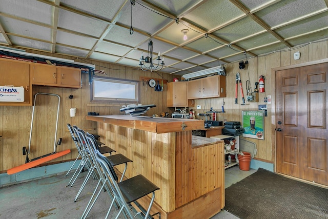 212 30th Ave N, Saint Cloud, MN 56303 - kitchen with wood walls, concrete flooring, and a kitchen bar