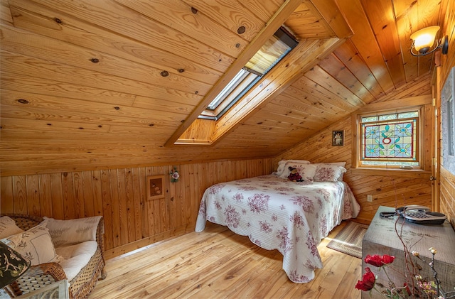 1116 Sand Lake Dr NW, Backus, MN 56435 - bedroom featuring wooden walls, vaulted ceiling, light wood-style flooring, a skylight, and wood ceiling