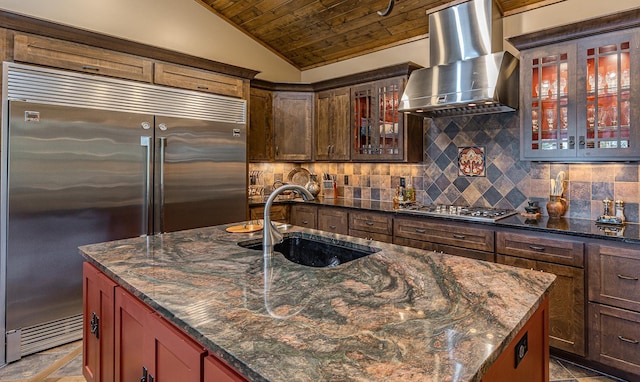 1116 Sand Lake Dr NW, Backus, MN 56435 - kitchen with stainless steel appliances, wall chimney range hood, wooden ceiling, tasteful backsplash, and dark stone countertops