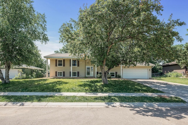 4909 98th St, Bloomington, MN 55437 - bi-level home with concrete driveway, a front lawn, and an attached garage