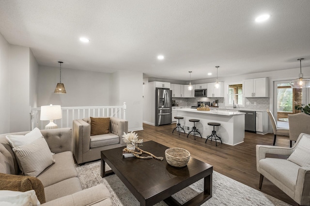 4909 98th St, Bloomington, MN 55437 - living room featuring recessed lighting, dark wood finished floors, and a textured ceiling