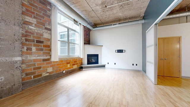 521 7th St Unit 519, Minneapolis, MN 55415 - unfurnished living room featuring wood finished floors and a glass covered fireplace