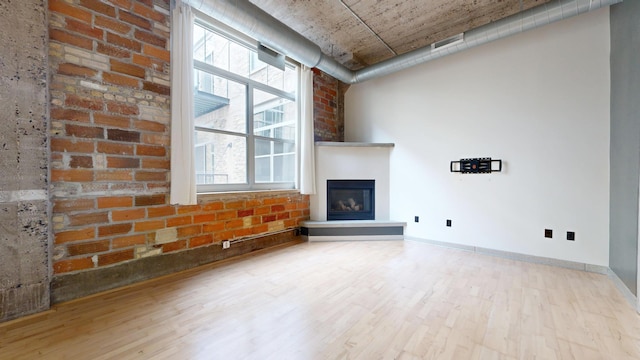 521 7th St Unit 519, Minneapolis, MN 55415 - unfurnished living room featuring wood finished floors, plenty of natural light, and a large fireplace
