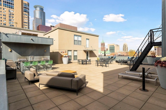 521 7th St Unit 519, Minneapolis, MN 55415 - view of patio / terrace with a view of skyline, stairs, outdoor dining area, and an outdoor living space