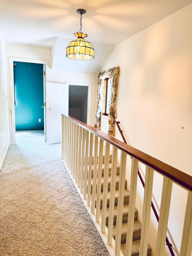 39130 Notebloom Ln, Waubun, MN 56589 - corridor with carpet floors, vaulted ceiling, an upstairs landing, and a textured ceiling