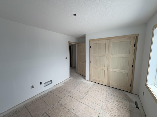 3617 Meadow Sage Ct SE, Rochester, MN 55904 - unfurnished bedroom featuring a textured ceiling