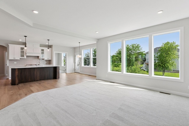 4720 131st Ave NE, Blaine, MN 55449 - unfurnished living room featuring light wood-style floors, recessed lighting, and arched walkways