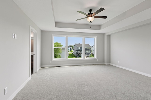 4720 131st Ave NE, Blaine, MN 55449 - carpeted empty room featuring a ceiling fan and a raised ceiling