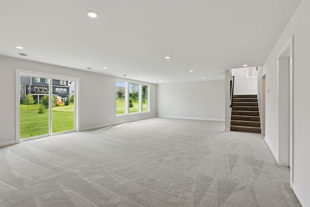4720 131st Ave NE, Blaine, MN 55449 - unfurnished living room with light colored carpet, stairway, and recessed lighting