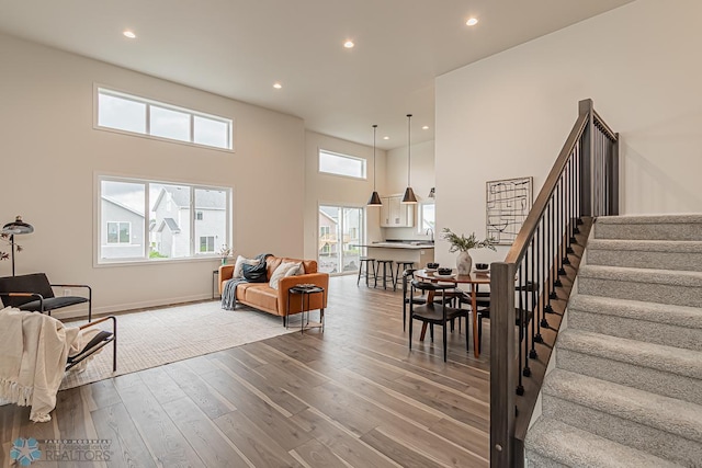 6724 32nd St S, Fargo, ND 58104 - living area with stairs, wood finished floors, recessed lighting, and a towering ceiling