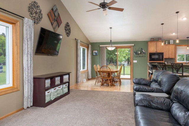 N8343 Mcwain Dr, Holland Twp, WI 54636 - living room with light carpet, healthy amount of natural light, a ceiling fan, and lofted ceiling